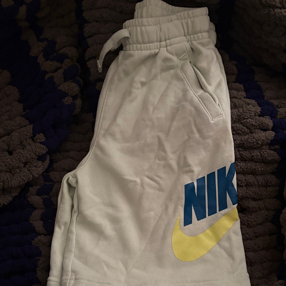 Nike White Kids Shorts with Blue Logo and Yellow Swoosh Accent